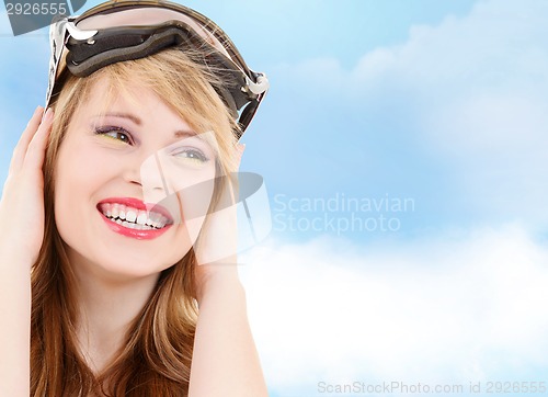 Image of smiling teenage girl in snowboard goggles
