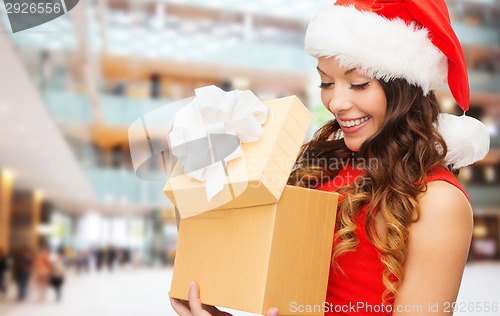 Image of smiling woman in red dress with gift box