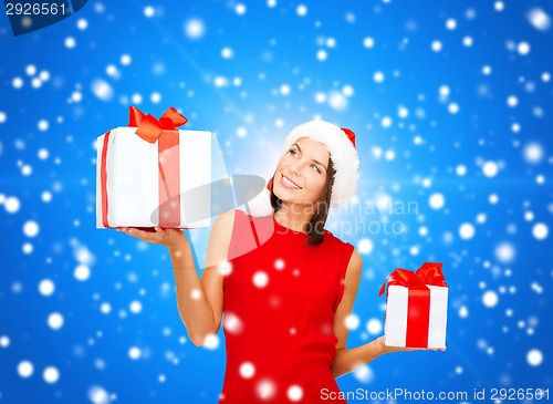 Image of smiling woman in red dress with gift box
