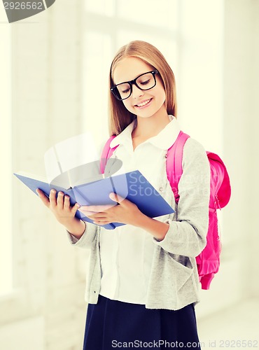 Image of girl reading book at school