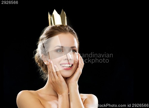 Image of laughing woman wearing golden crown
