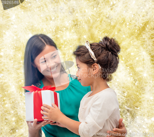 Image of happy mother and child girl with gift box