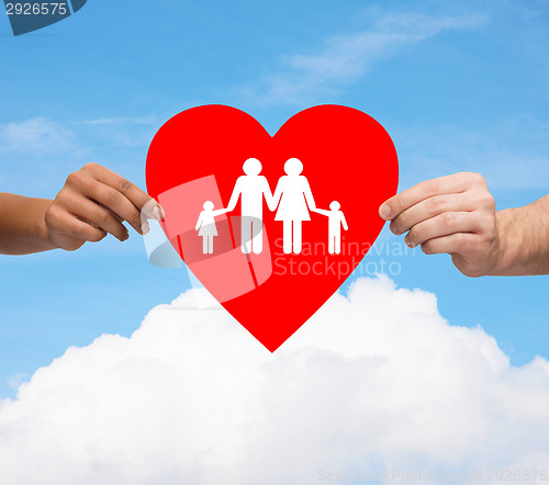 Image of couple hands holding red heart with family