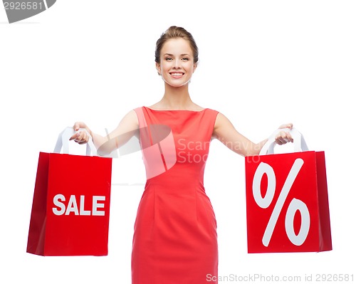 Image of young woman in red dress with shopping bags