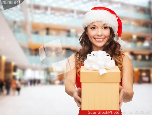 Image of smiling woman in red dress with gift box