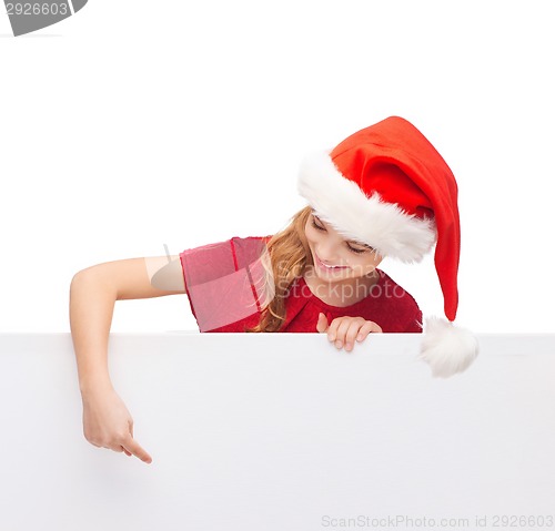 Image of child in santa helper hat with blank white board