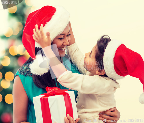 Image of happy mother and child girl with gift box