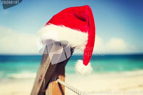 Image of close up of santa helper hat on beach