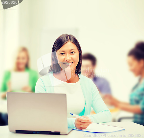Image of asian businesswoman with laptop and documents