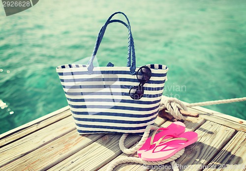 Image of close up of beach accessories on wooden pier