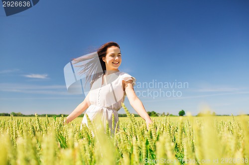 Image of smiling young woman on cereal field