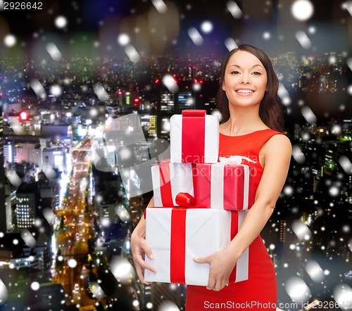 Image of smiling woman in santa helper hat with gift box