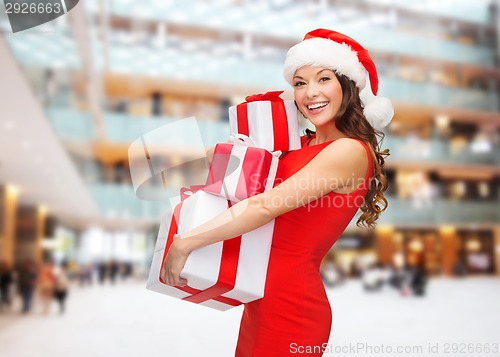 Image of smiling woman in red dress with gift box