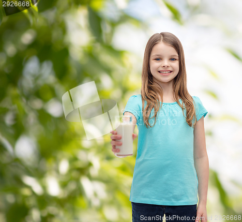 Image of smiling little girl giving glass of milk