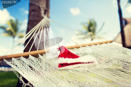 Image of picture of hammock with santa helper hat