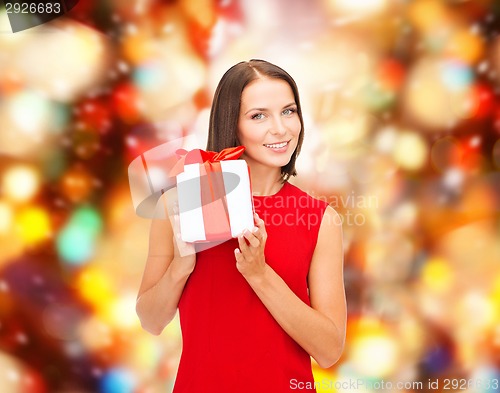 Image of smiling woman in red dress with gift box