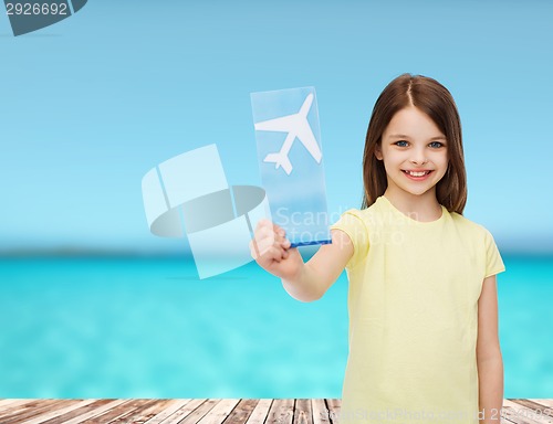 Image of smiling little girl with airplane ticket