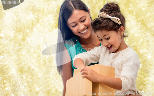 Image of happy mother and child girl with gift box