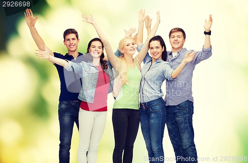 Image of group of smiling students waving hands