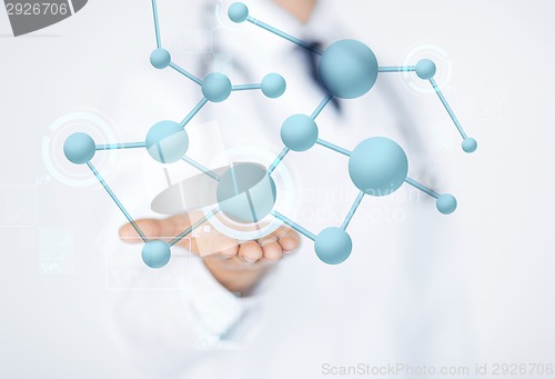 Image of close up of male doctor hand with molecules