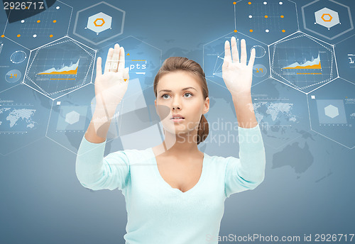 Image of smiling businesswoman working with virtual screen