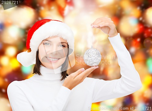 Image of woman in santa helper hat with christmas ball