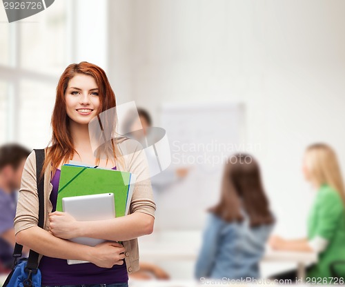 Image of smiling student with bag, folders and tablet pc