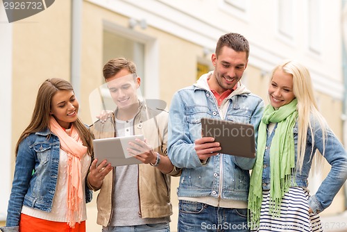 Image of group of smiling friends with tablet pc computers