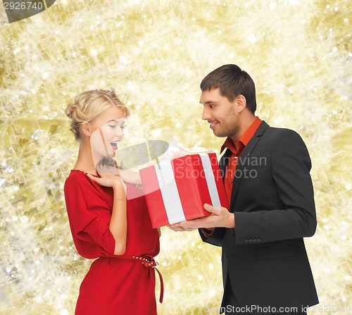 Image of smiling man and woman with present
