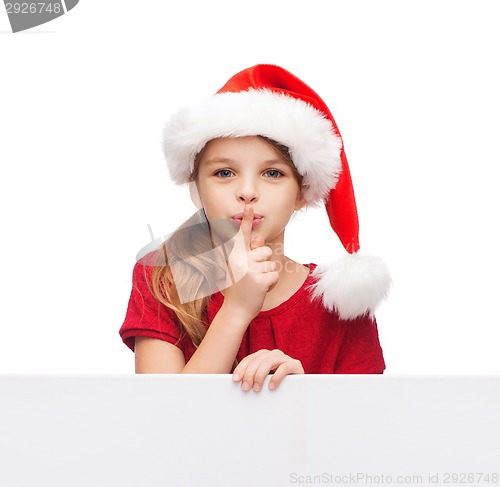 Image of child in santa helper hat with blank white board