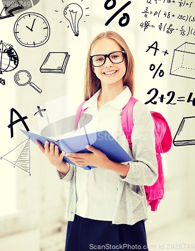 Image of girl reading book at school