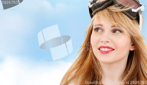 Image of smiling teenage girl in snowboard goggles