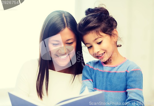 Image of mother and daughter with book