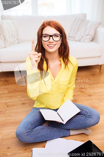 Image of smiling teenage girl with tablet pc at home