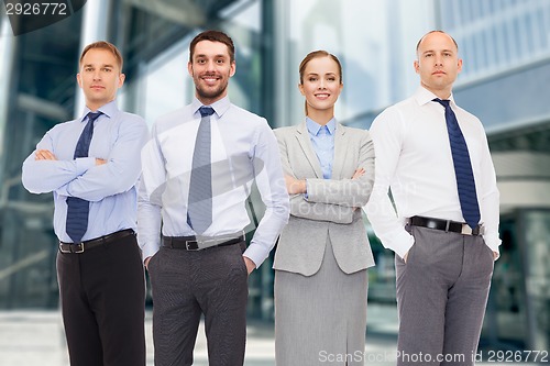 Image of group of smiling businessmen outdoors