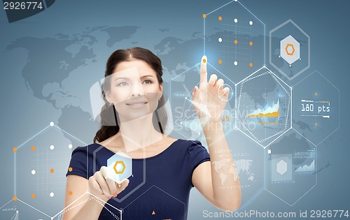 Image of smiling businesswoman working with virtual screen