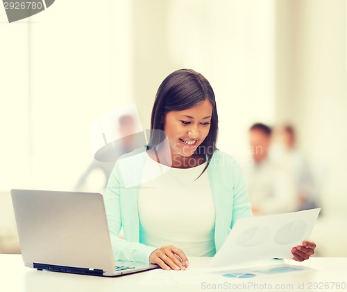 Image of asian businesswoman with laptop and documents