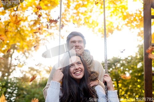 Image of smiling couple hugging in autumn park