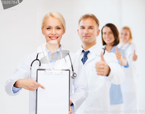 Image of smiling female doctor with clipboard