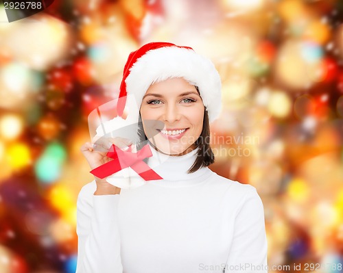 Image of smiling woman in santa helper hat and jingle bells