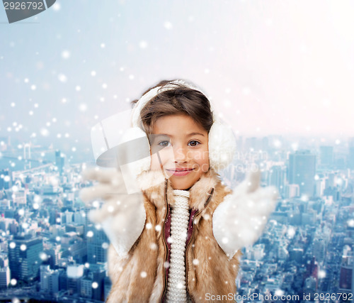Image of smiling little girl in winter clothes