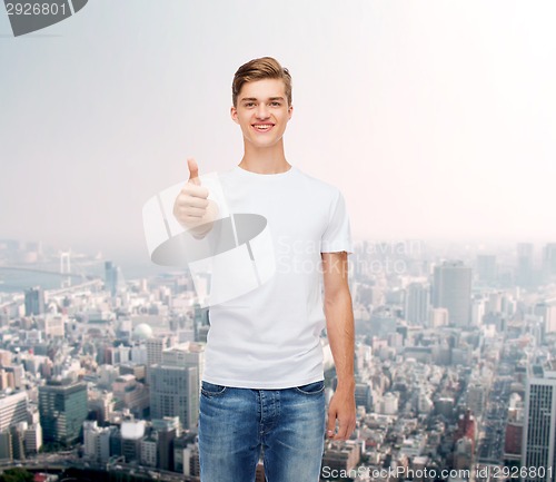 Image of smiling man in white t-shirt showing thumbs up