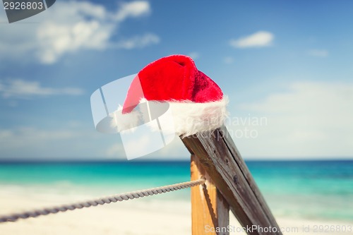 Image of close up of santa helper hat on beach