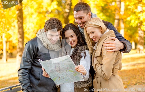 Image of group of friends with map outdoors