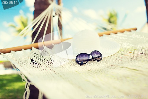 Image of picture of hammock with white hat and sunglasses