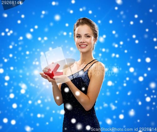 Image of smiling woman holding red gift box