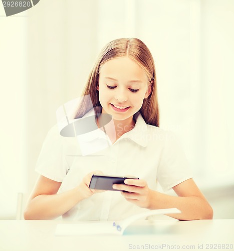 Image of girl with smartphone at school