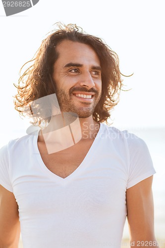 Image of smiling man in white blank shirt outdoors
