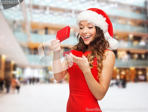 Image of smiling woman in red dress with gift box