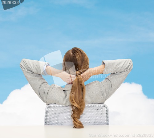 Image of businesswoman sitting on chair from back